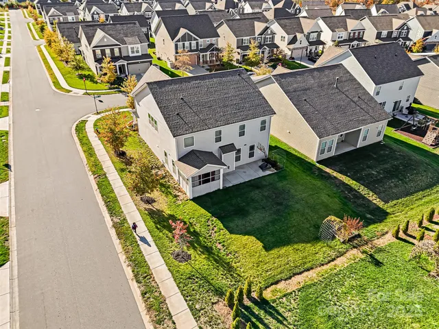 an aerial view of a house with swimming pool