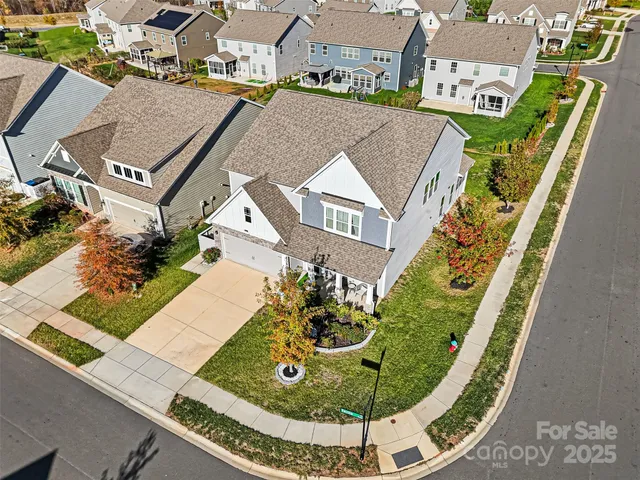 an aerial view of a house with a swimming pool