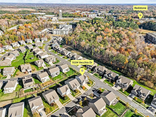 an aerial view of residential houses with outdoor space