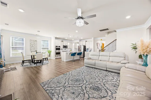 a living room with furniture and wooden floor