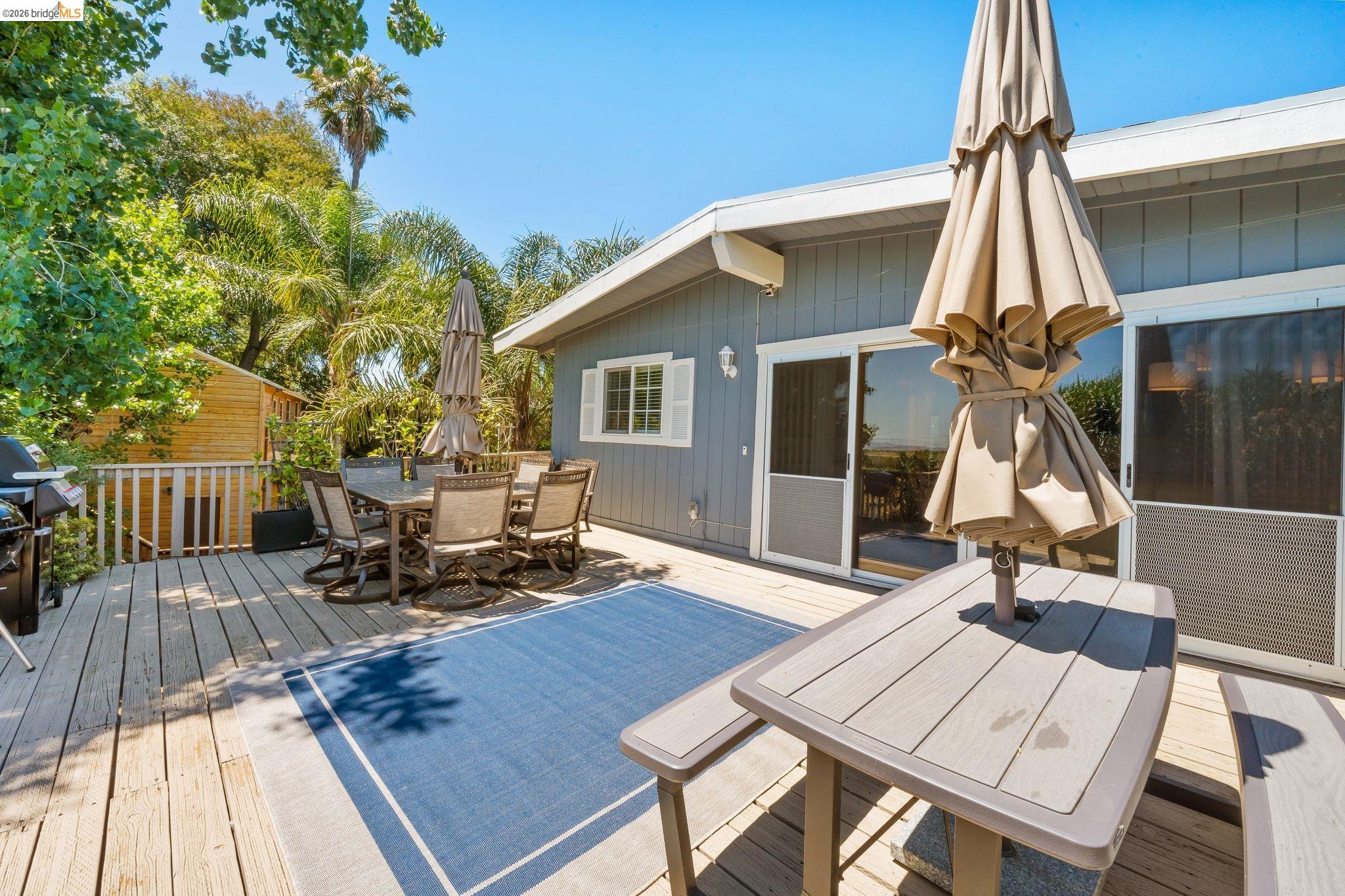 1704 Taylor Road Bethel Island, CA 94511 - Photo 43 of 73 Expansive wood deck with a built-in railing, offering multiple seating areas