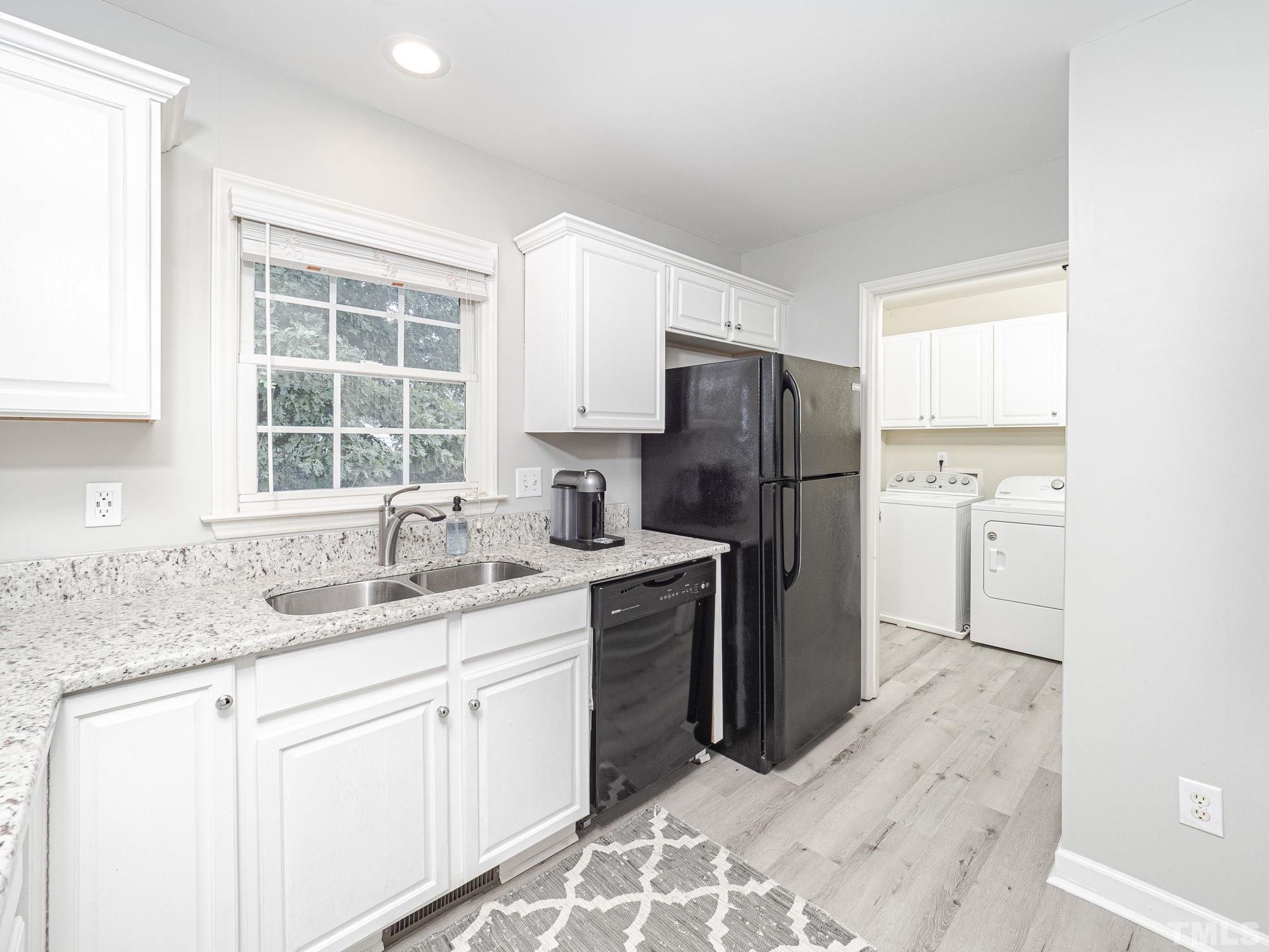 9504 Dawnshire Road Raleigh, NC 27615 - Photo 13 of 30 a kitchen with a sink stove and refrigerator
