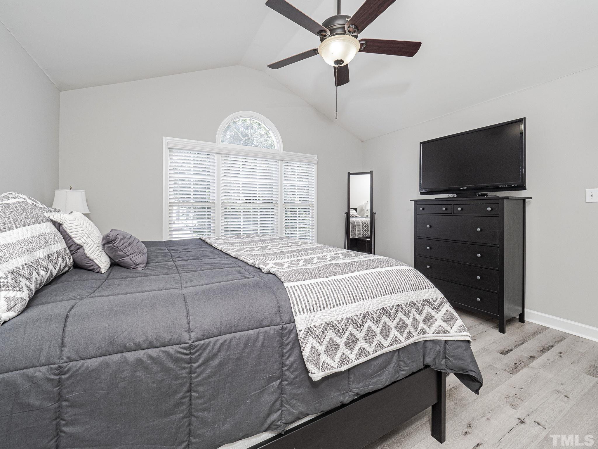 9504 Dawnshire Road Raleigh, NC 27615 - Photo 18 of 30 a bedroom with a bed and a flat screen tv