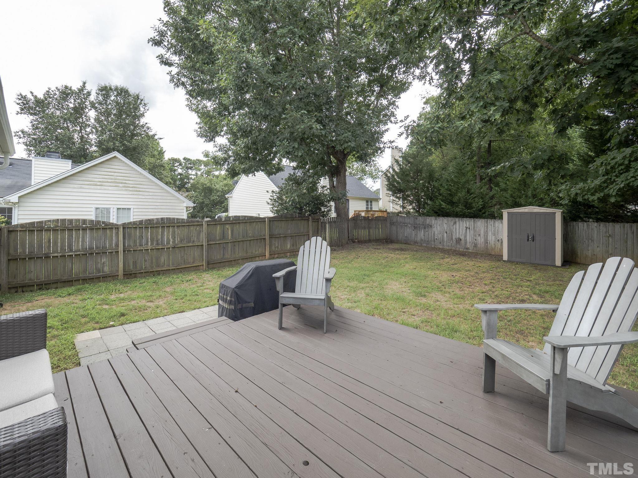 9504 Dawnshire Road Raleigh, NC 27615 - Photo 25 of 30 a view of a deck with chair and wooden floor