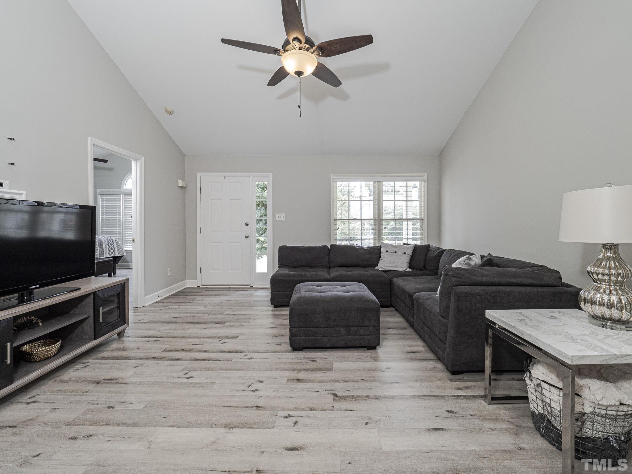 9504 Dawnshire Road Raleigh, NC 27615 - Photo 6 of 30 a living room with furniture and a flat screen tv