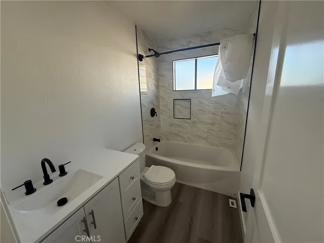 a bathroom with a sink toilet tub and shower