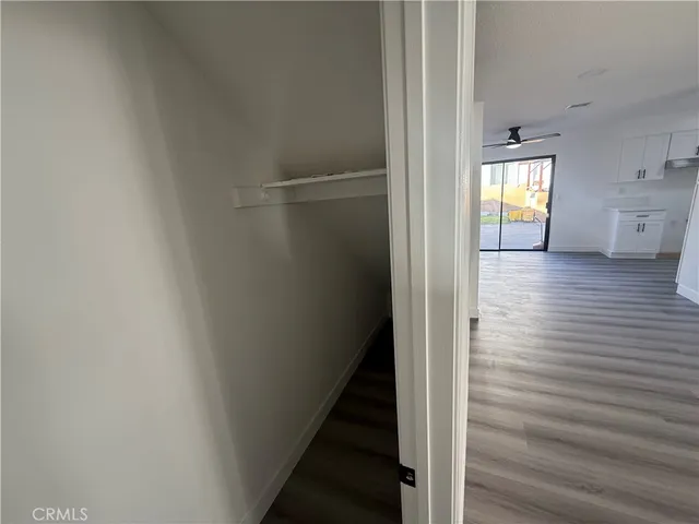 a view of a hallway with wooden floor