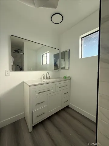 a bathroom with a double vanity sink and mirror