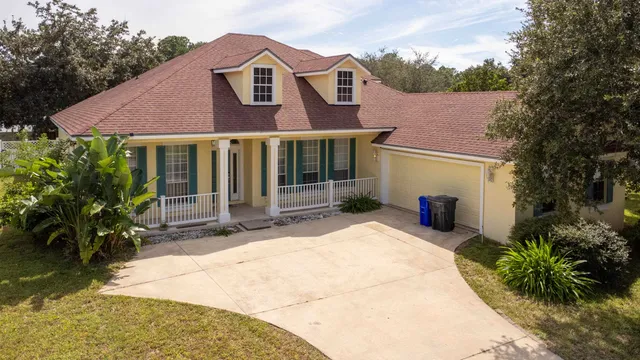 a view of a house with a small yard and plants
