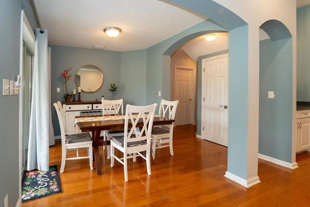 a living room with furniture and kitchen view