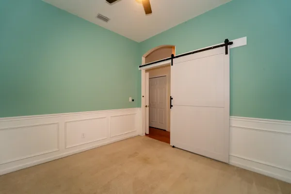 a bed sitting in a room next to a window