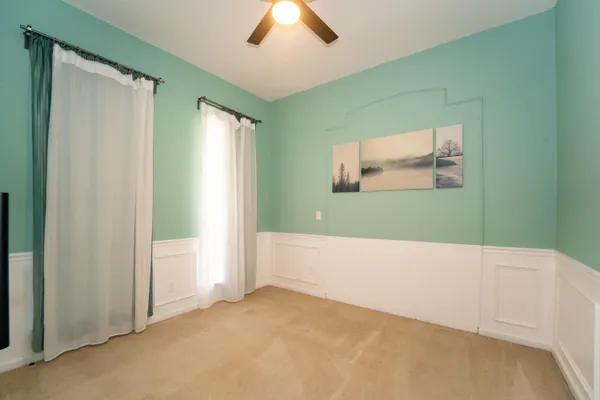 a view of a bedroom with wooden floor and closet