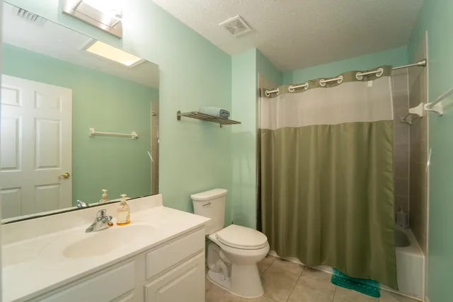 a bedroom with a bed and lamp