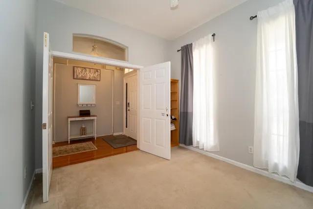 a bedroom with two beds and painting on the wall
