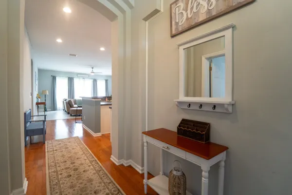 a kitchen with a refrigerator a sink and a stove top oven with wooden floor