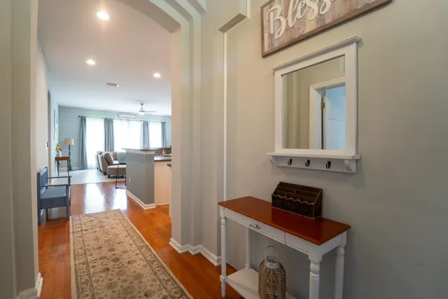 a kitchen with a refrigerator a sink and a stove top oven with wooden floor