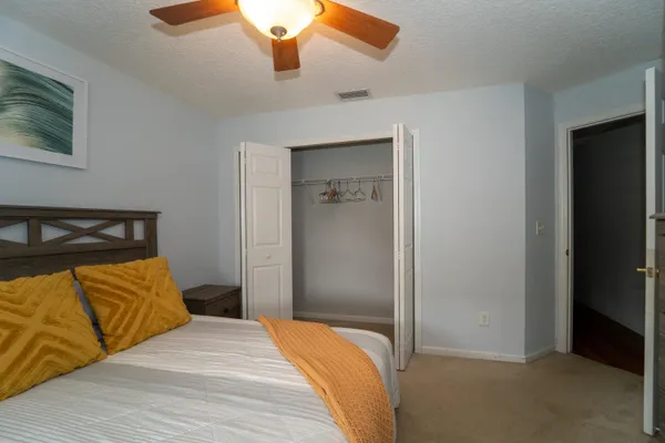 a view of a house with a small yard and wooden floor and fence