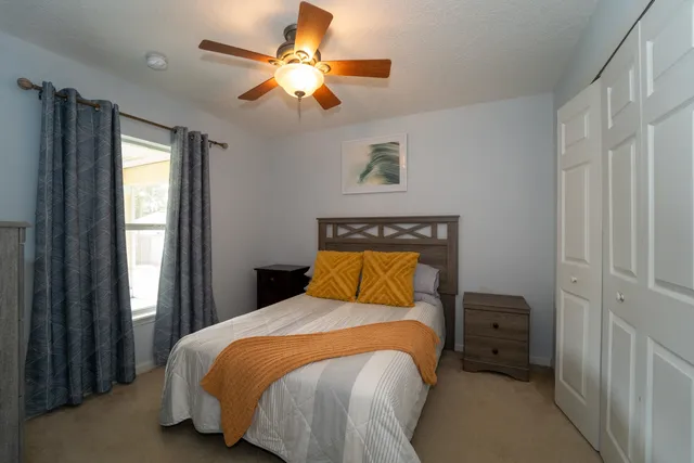 a front view of house with yard and trees around