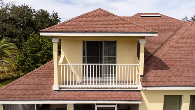 an aerial view of house with yard and ocean view