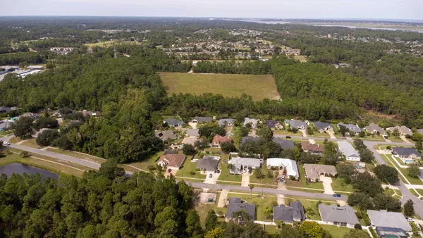 an aerial view of residential houses with outdoor space