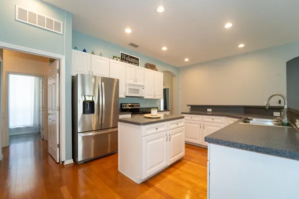 a kitchen with stainless steel appliances granite countertop a stove and a sink