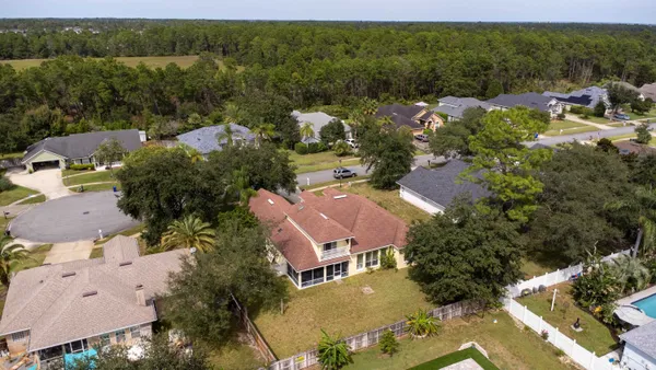 an aerial view of houses with yard