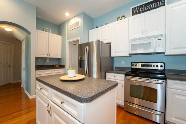 a large white kitchen with a large window