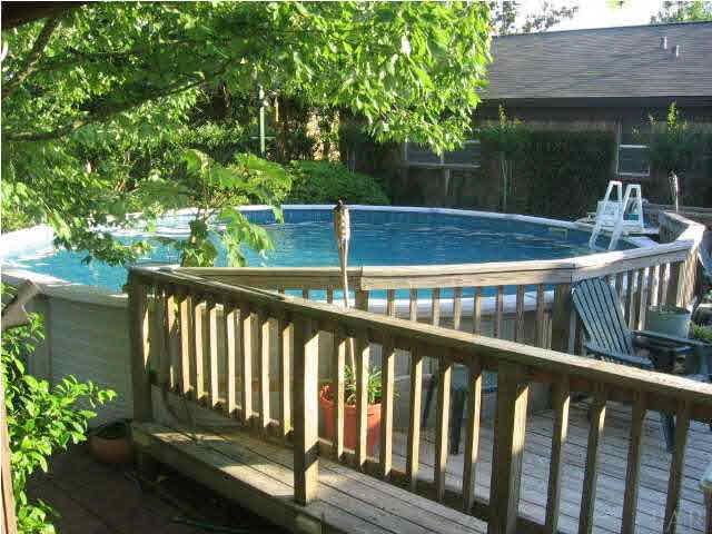 8224 Squire Road Pensacola, FL 32514 - Photo 1 of 22 Above ground pool with deck, and tiki torches.