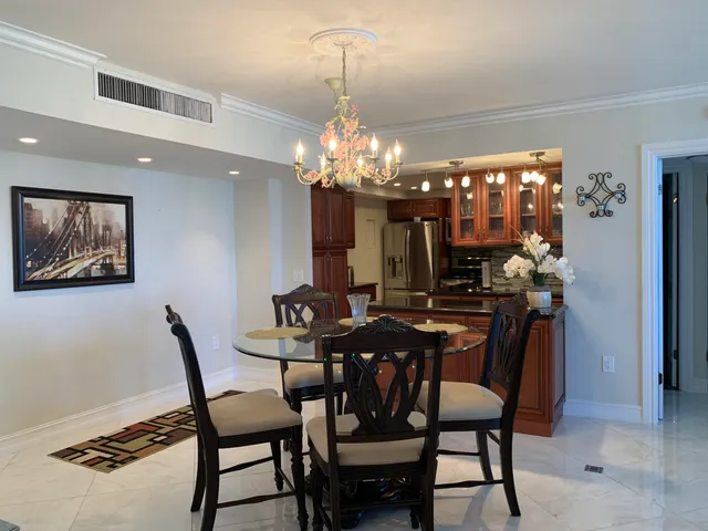 a view of a dining room with furniture and chandelier