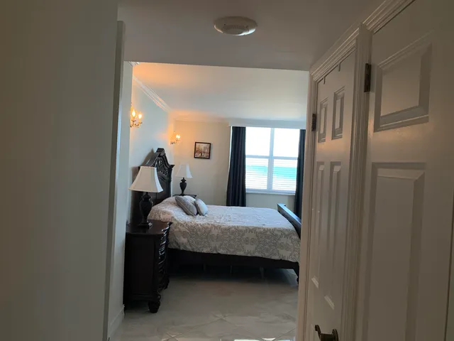 a room with a bed and a mirror