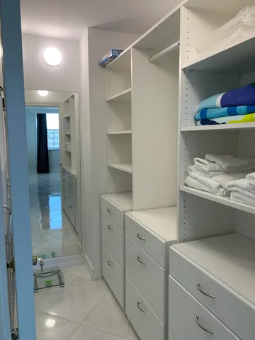 a room with a wooden floor and cabinets