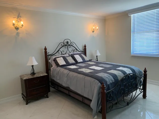 a bedroom with a bed and a lamp