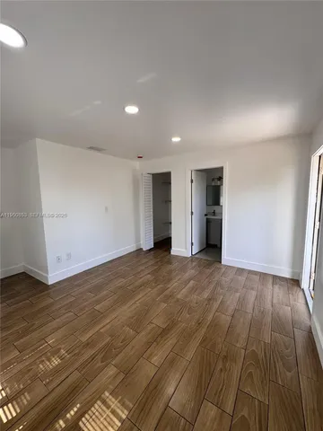 an empty room with an empty space and a sink