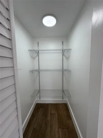 a view of a room with wooden floor and staircase