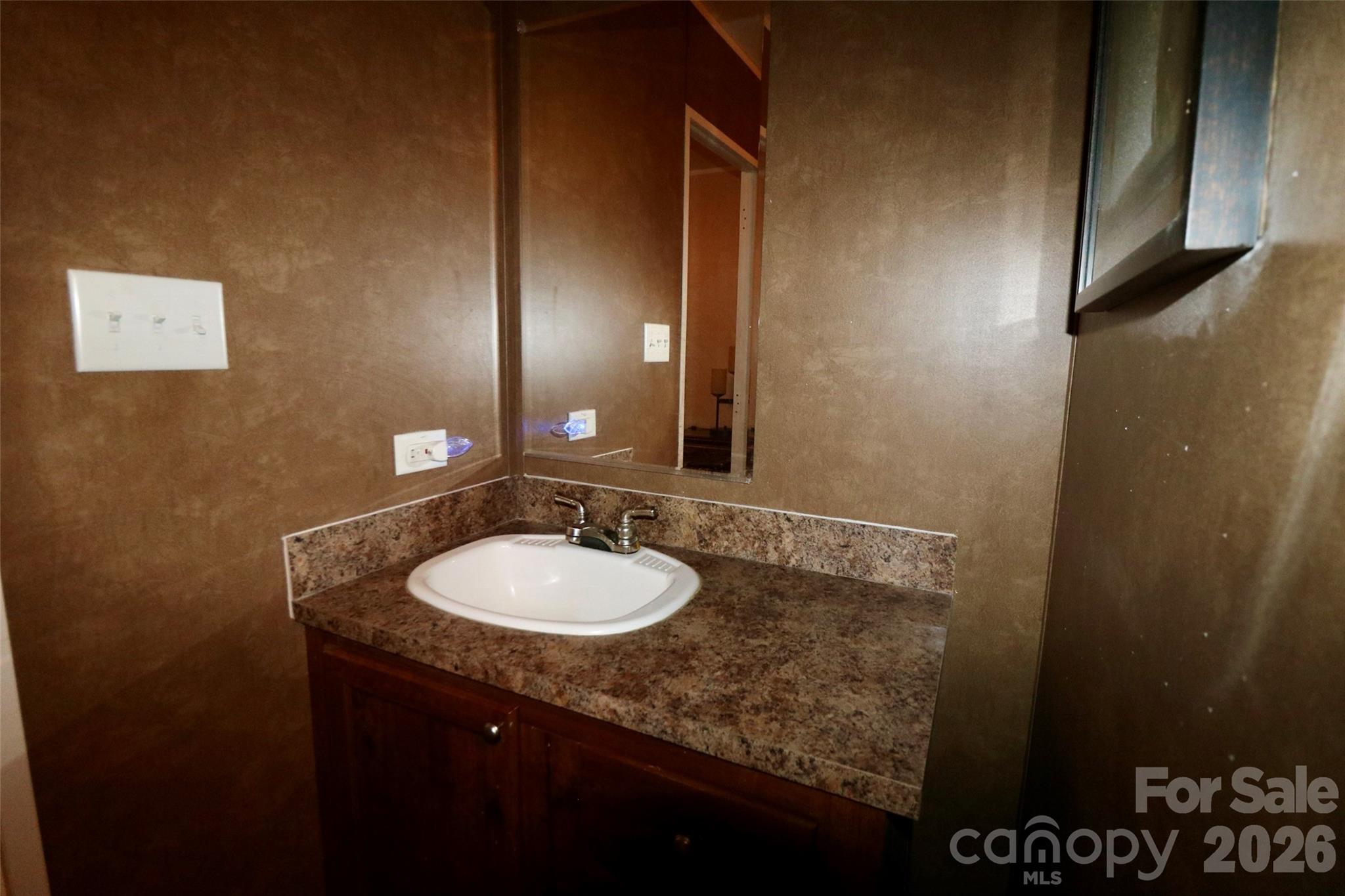 116 Sienna Court Grover, NC 28073 - Photo 11 of 19 a bathroom with a granite countertop sink and a mirror