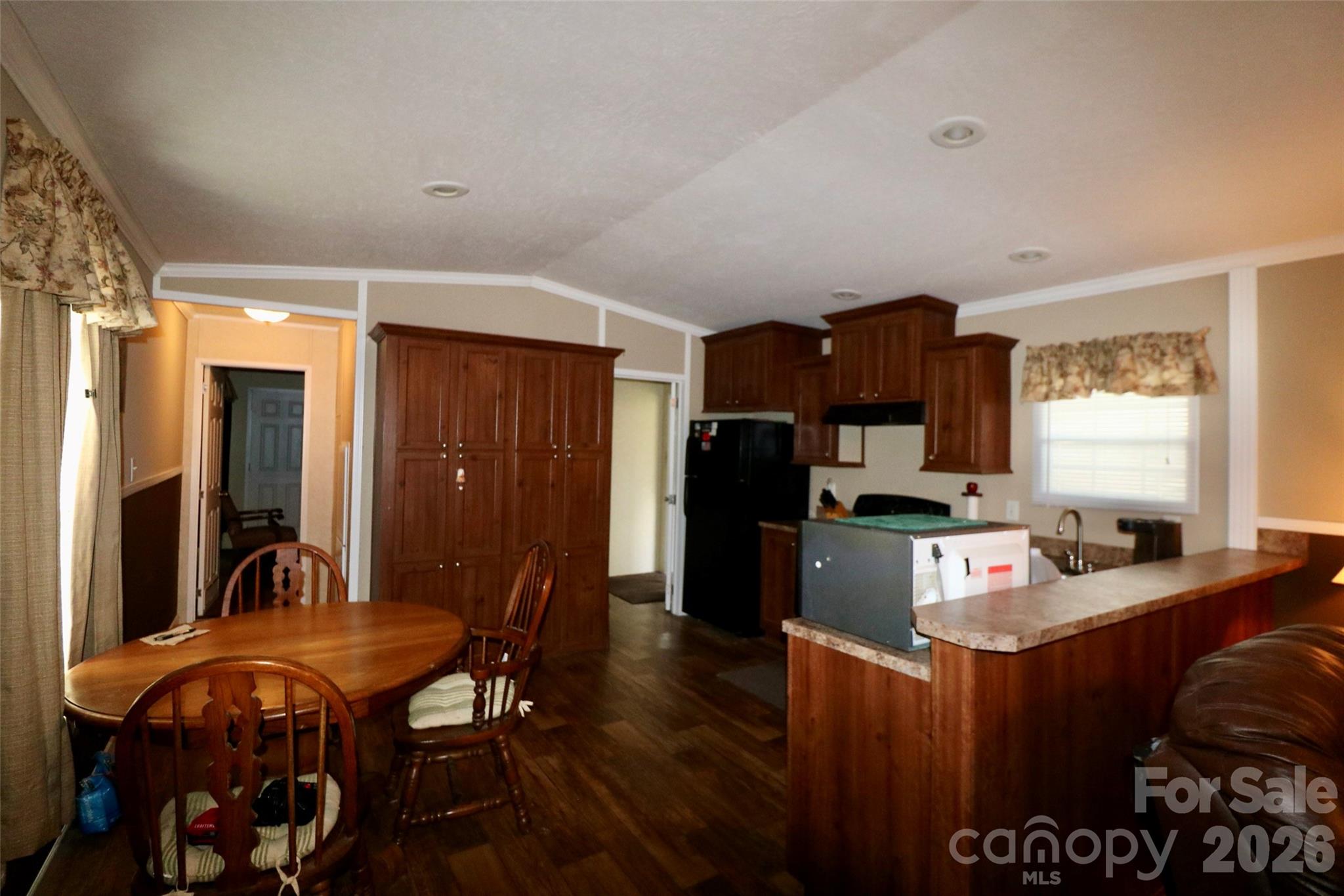 116 Sienna Court Grover, NC 28073 - Photo 7 of 19 a open kitchen with stainless steel appliances granite countertop a stove a refrigerator a sink a dining table and chairs with wooden floor