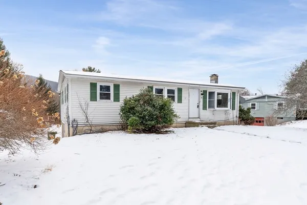 a view of a house with snow on the road