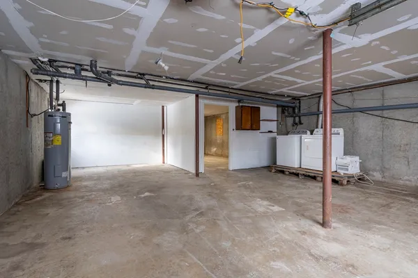 a view of empty room with wooden floor and windows