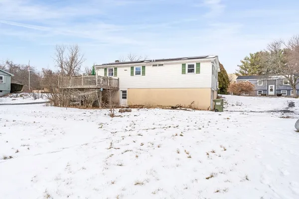 a view of the house in the snow yard
