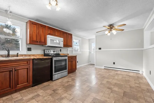 a kitchen with stainless steel appliances granite countertop a stove cabinets and sink