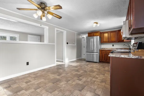 a view of a kitchen with a sink and a refrigerator