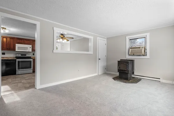 a view of a livingroom with an empty space and a fireplace