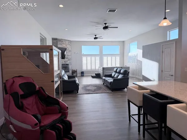 a living room with furniture ceiling fan and a window