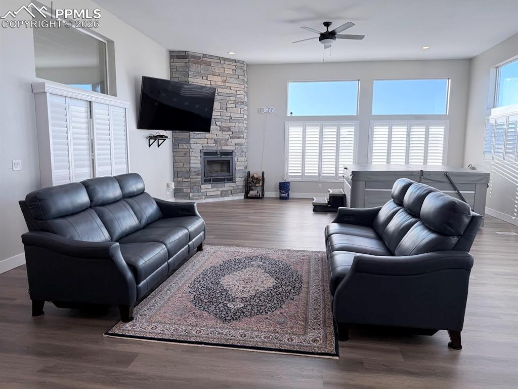 11970 Silver Concho Trail Elbert, CO 80106 - Photo 14 of 44 a living room with furniture a fireplace and a flat screen tv