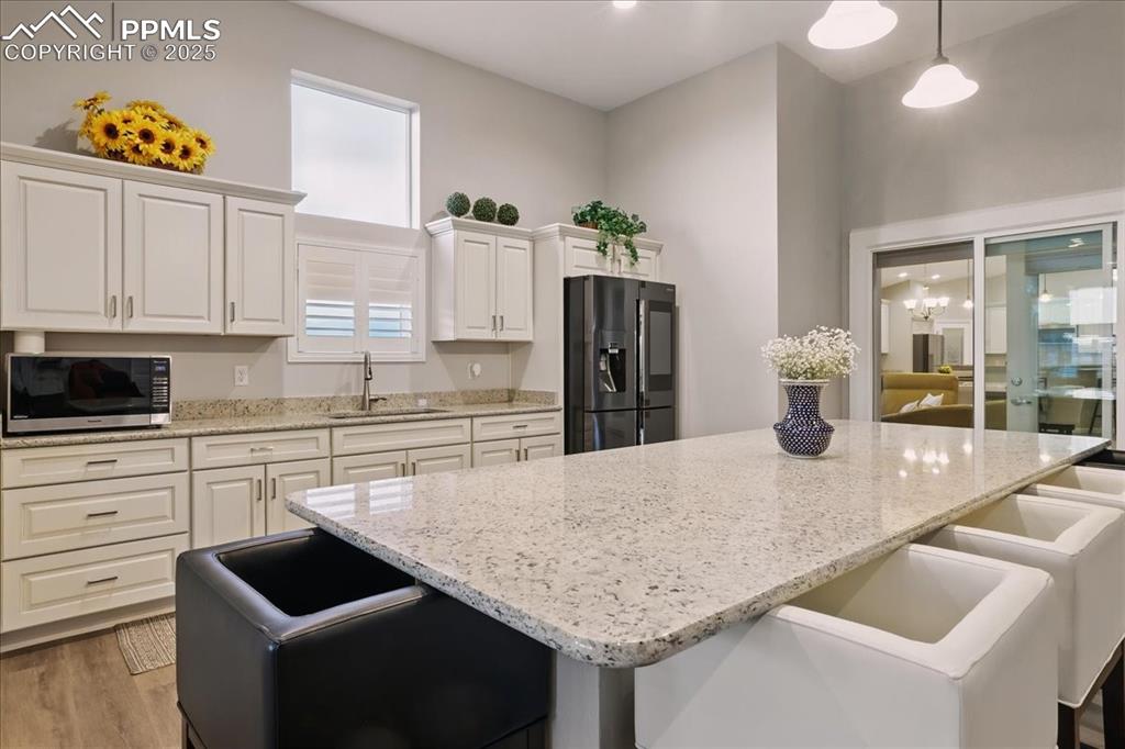 11970 Silver Concho Trail Elbert, CO 80106 - Photo 20 of 44 a kitchen with granite countertop kitchen island stainless steel appliances a refrigerator stove and sink