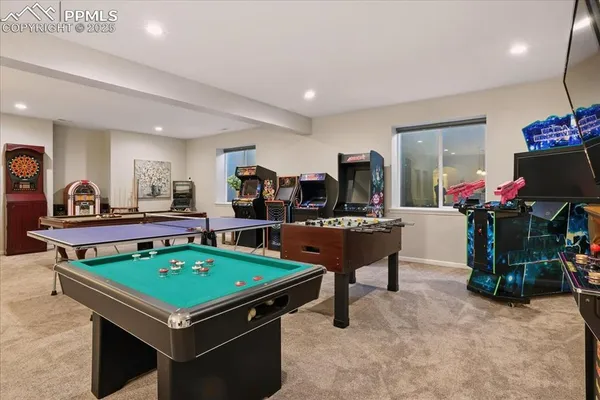 a room with pool table and windows