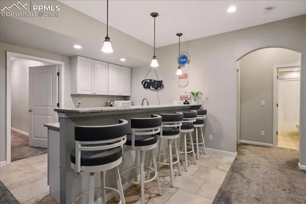 a kitchen with a dining table cabinets and appliances