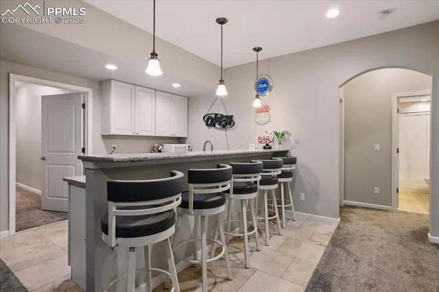 a kitchen with a dining table cabinets and appliances
