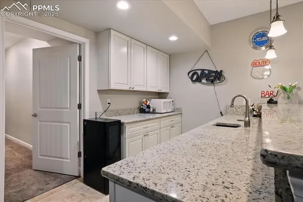 a kitchen with a sink refrigerator and cabinets