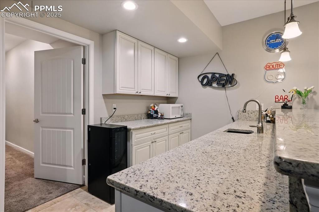 11970 Silver Concho Trail Elbert, CO 80106 - Photo 28 of 44 a kitchen with a sink refrigerator and cabinets